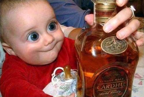 Baby mit riesigen Augen hat Whiskey Flasche